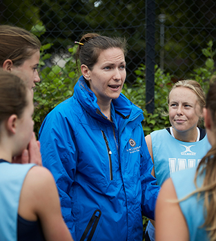Netball coach with team