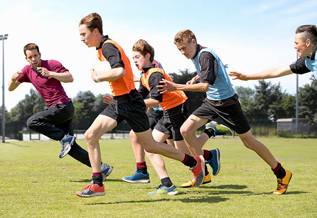 Rugby players and coach running