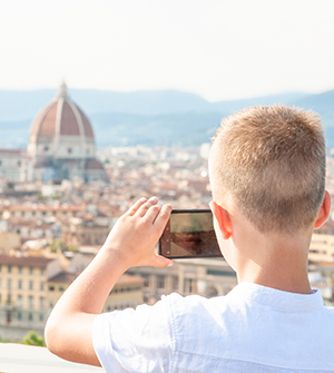 Student taking photo across Florence