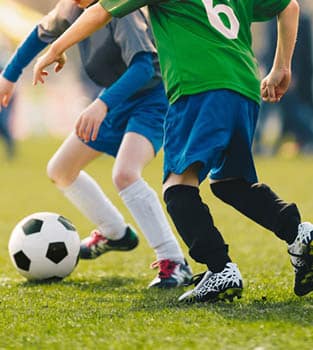Teenage boys competing in a football game