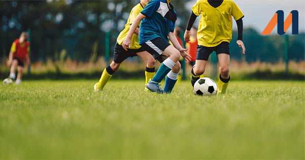 Teenagers playing football
