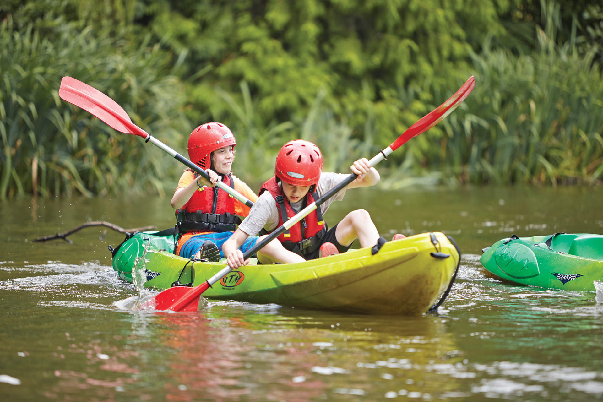 Students kayaking on a lake