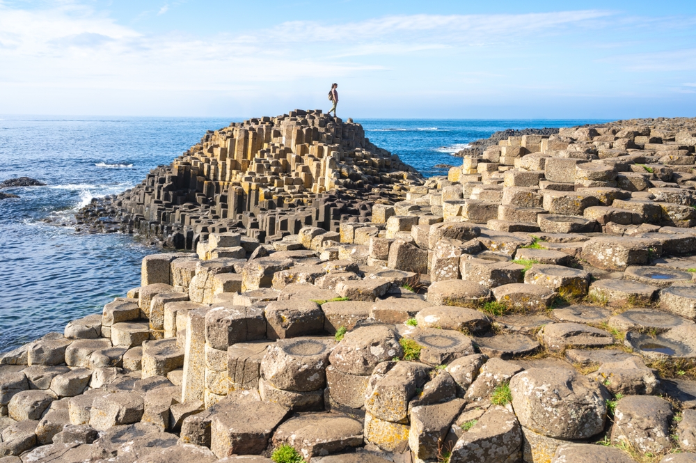Person standing on Giants Causeway in Portrush, Norther Ireland