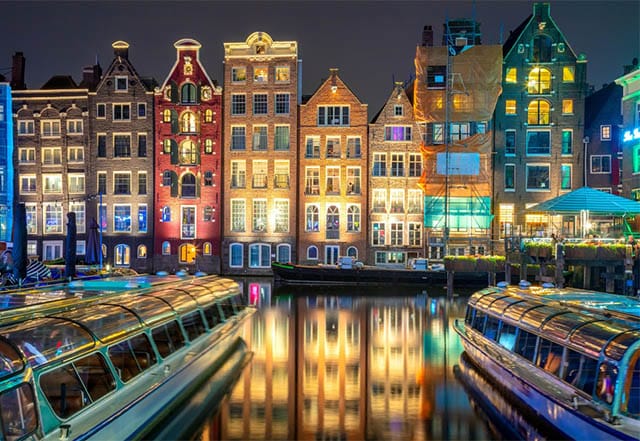 Old houses by the canals of Amsterdam at night