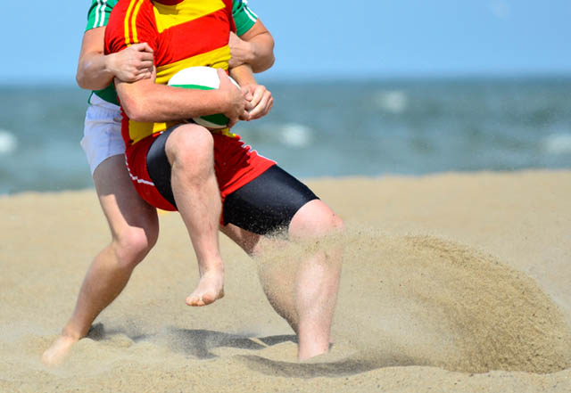 Rugby players training on the beach