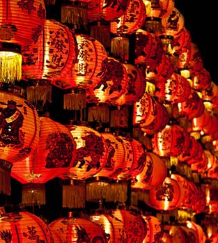 A wall of Chinese red lanterns glowing in the dark