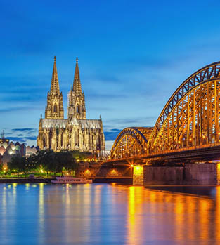 Cologne at dusk with the bridge and gothic cathedral