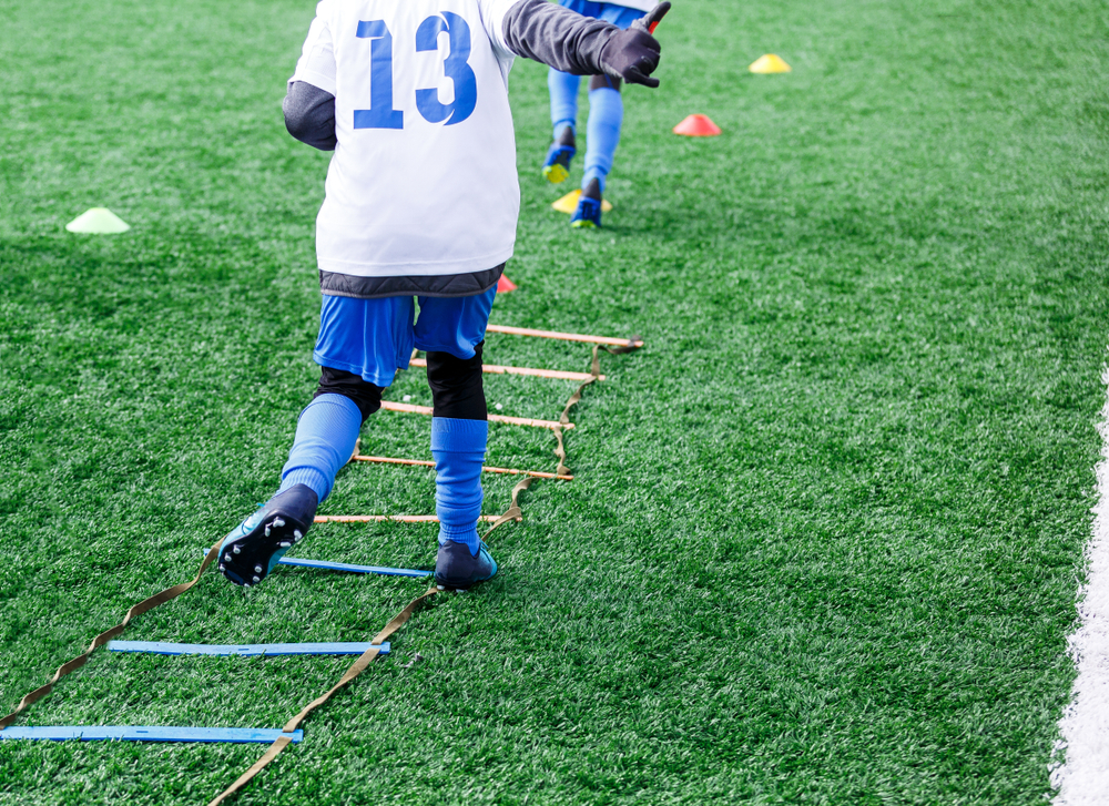 Boy wearing blue and white jersey during football training