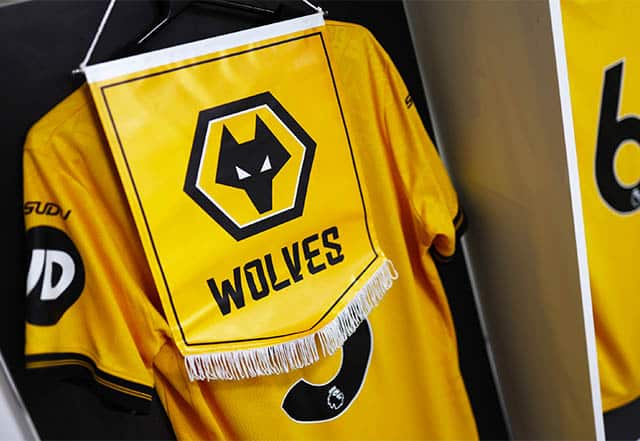 The yellow Wolverhampton FC jersey and flag on display at the city's stadium