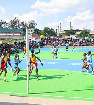 Teams playing netball out in the sunshine in Malawi