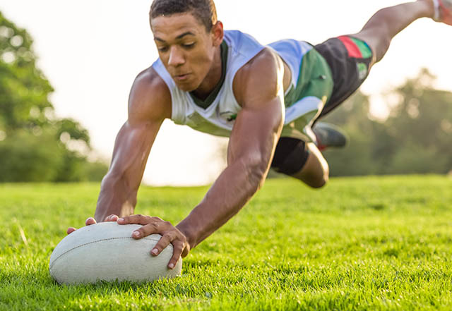 Rugby player diving for the ball