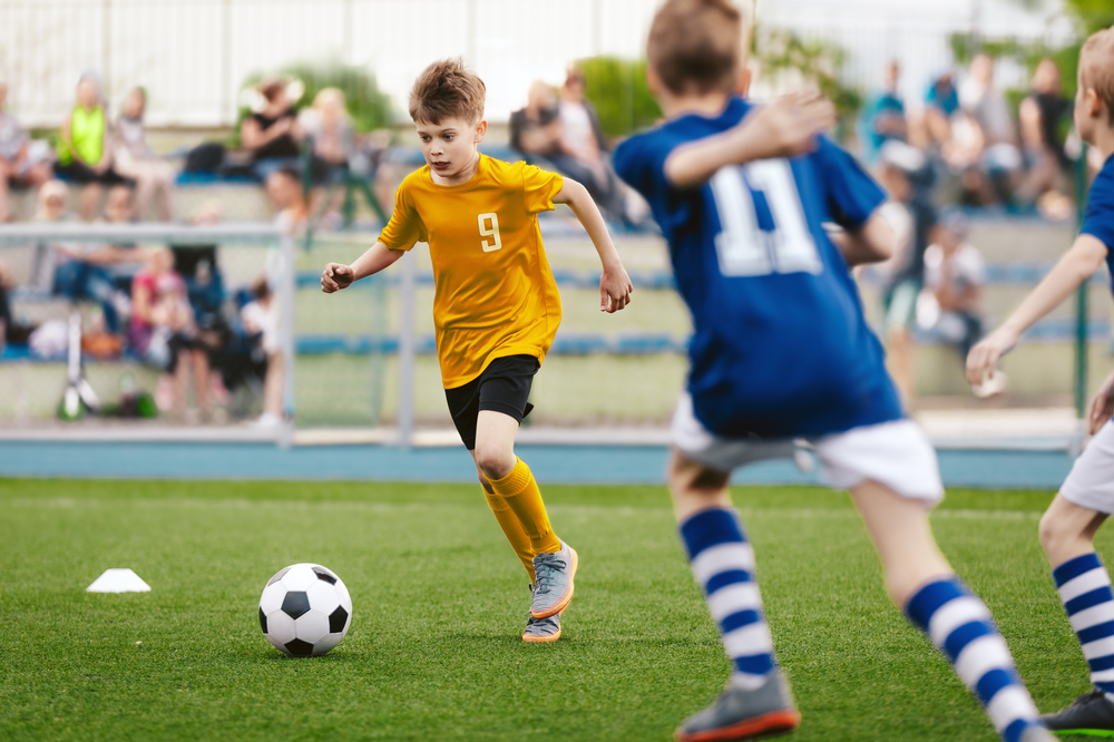 Young boys playing football