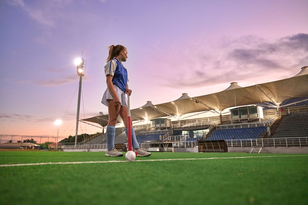 Hockey female player on pitch