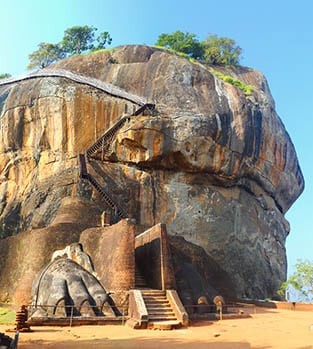 Student girl posing in front of the Sigiriya Rock Fortress in Sri Lanka.