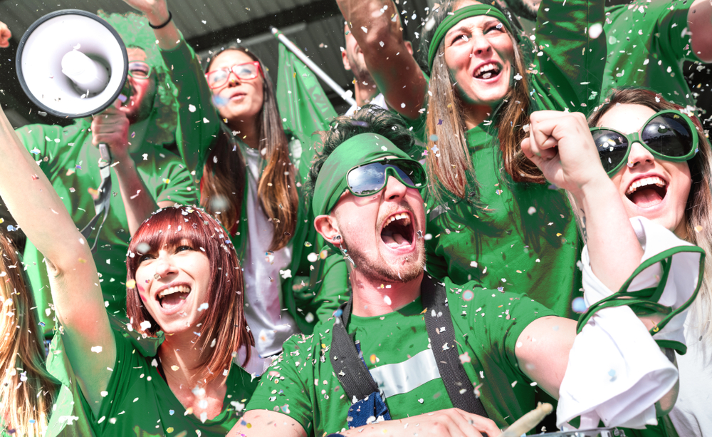 Rugby supporters wearing green at a rugby match