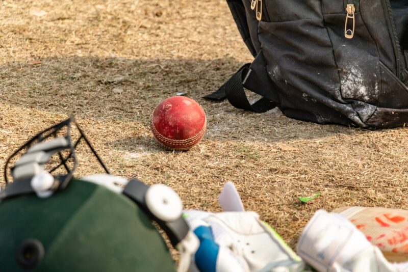 Cricket ball and bags on the ground