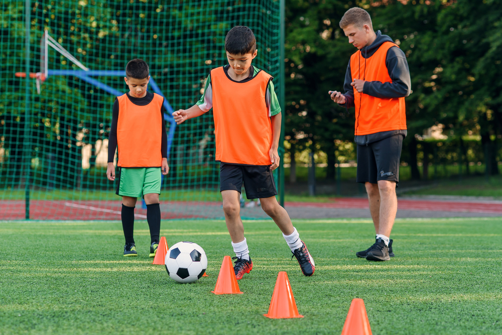Boys wearing orange jerseys during a training session