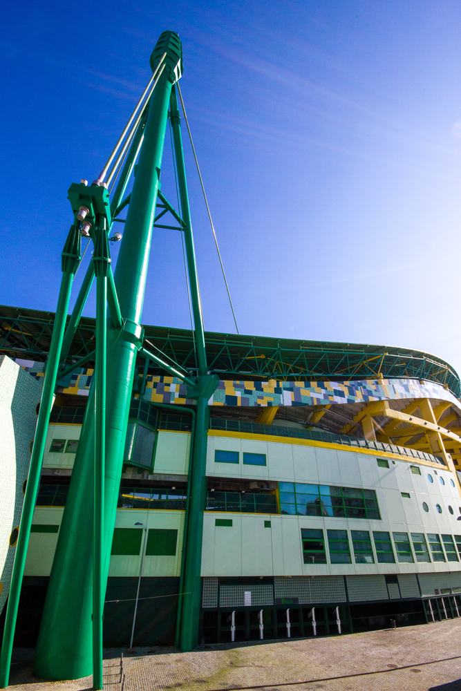 The colourful green and yellow gates of Estado Jose Alvalade in Lisbon, Portugal