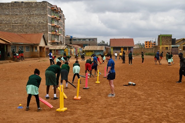 Local children learning to play cricket in Kenya