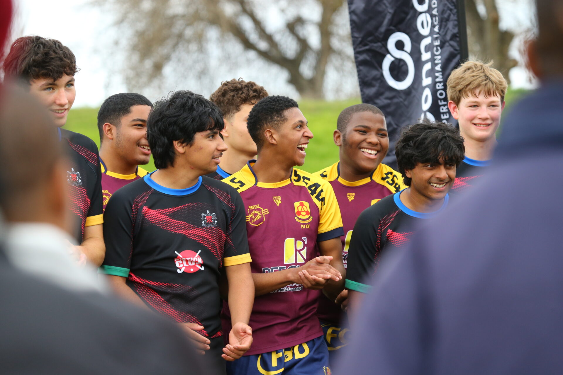 Rugby players from competing teams smiling together at the Festival of Unity in South Africa